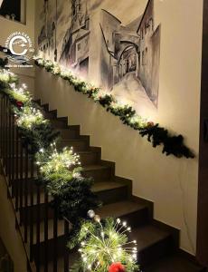 a staircase decorated with christmas lights and garland at Pensiunea Carmen - Bikers Friendly Nest in Sibiu