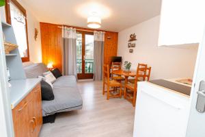 a living room with a couch and a table at Escapade Au Calme De La Rivière in Métabief +28 photos