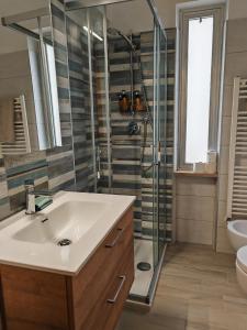 a bathroom with a sink and a shower at Beach Apartments Montesilvano Pescara in Montesilvano +51 photos