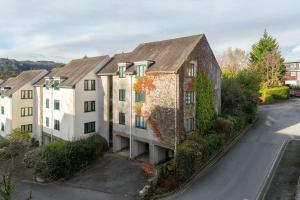 an apartment building with ivy on the side of a street at Mulberry in Bowness-on-Windermere