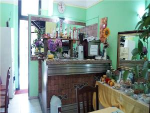 a bar in a restaurant with a table and a mirror at Hotel Stazione in Novara