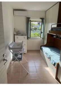 a room with a bed and a table and a window at Villetta da sogno fronte mare in Bianco