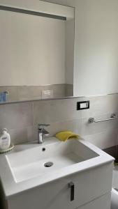 a bathroom with a sink and a mirror at Ampio bilocale vicino al mare in Borghetto Santo Spirito