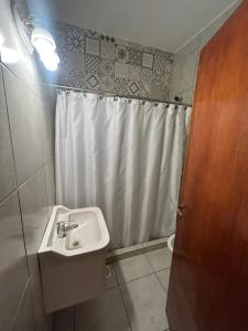a bathroom with a sink and a shower curtain at Casa catamarca in San Rafael