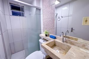 a bathroom with a sink and a toilet at Apê Sofisticado I Wi-Fi e A/C in Imperatriz +16 photos