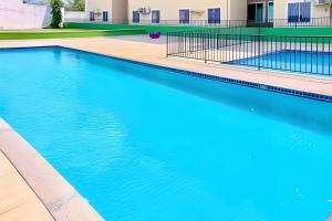 a large swimming pool with blue water at Apê Sofisticado com Piscina I Wi-Fi e A/C in Imperatriz