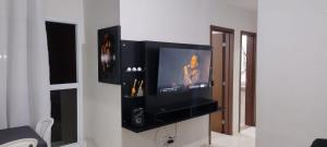 a flat screen tv on a wall in a living room at Apartamento das Estrelas in Palmas