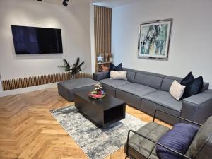 a living room with a couch and a table at Newly Renovated Flat with Parking space in Canterbury