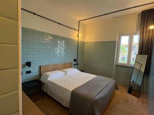 a bedroom with a bed and a window at Re Versiliana Hotel in Marina di Pietrasanta