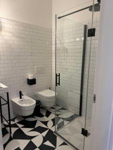a bathroom with a toilet and a glass shower at Re Versiliana Hotel in Marina di Pietrasanta