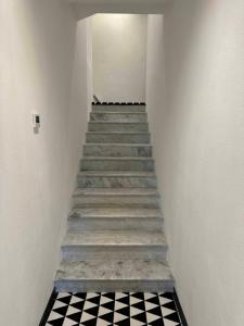 a stairway with a black and white checkered floor at Re Versiliana Hotel in Marina di Pietrasanta