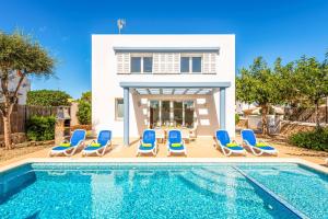 a villa with a swimming pool in front of a house at Villa Mar in Cala'n Bosch