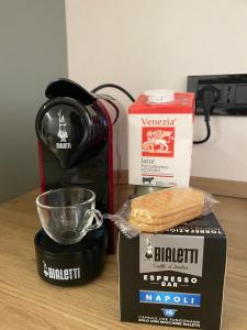 a table with a coffee maker and a box of bread at La casetta al parco in Ponte San Nicolo +18 photos