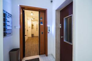 a hallway with a wooden door and a hallway with a hallway at Luz de Salento B&B in Lecce