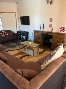 a living room with a couch and a fireplace at Mos Elkin Home in Kimberley