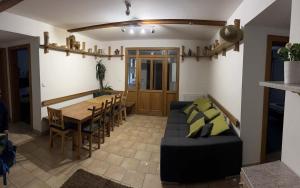 a living room with a couch and a table and chairs at Chata Paperule in Horní Maršov