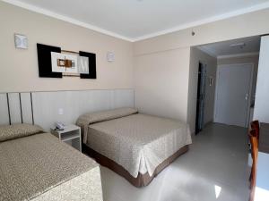 Cama ou camas em um quarto em Spazzio Diroma - Acesso gratuito ao Acqua Park e Splash