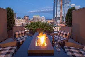 a fire pit on a balcony with a view of a city at Sentinel Hotel in Portland