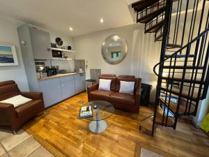 a living room with two chairs and a table at The Lodge at Bodenlodge in Malahide