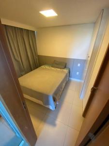 une petite chambre avec un lit dans une pièce dans l'établissement Cobertura 3 suítes com 1 dependência, à Pirangi do Norte