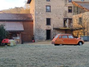 an orange car parked in front of a building at Gîte du Longevent in Meximieux