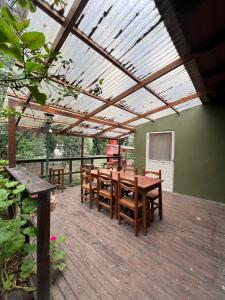 a patio with a wooden table and wooden chairs at Casa del Bosque in Mar del Plata