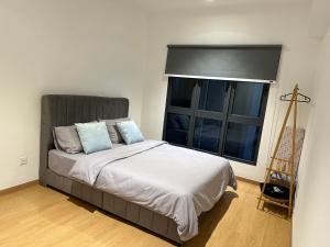 a bedroom with a bed and a large window at Maya Bay Splash Mania Pool View Cozy Homestay KLIA in Banting +14 photos