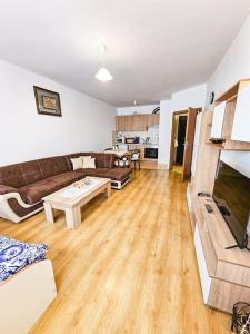 a living room with a couch and a table at Mountain Dream A8 apartment in Borovets