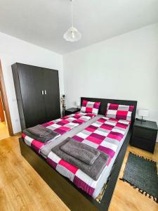 a bedroom with a bed with a checkered blanket at Mountain Dream A8 apartment in Borovets