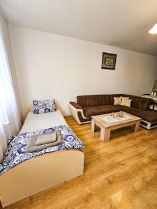 a living room with two beds and a couch at Mountain Dream A8 apartment in Borovets +8 photos