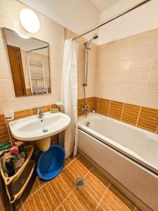 a bathroom with a sink and a tub and a mirror at Mountain Dream A8 apartment in Borovets