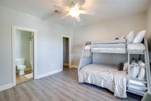a room with two bunk beds in it with a ceiling fan at Relaxing Biloxi Vacation Rental Condo Near Beach! in Biloxi +21 photos