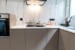a kitchen with two pots and pans on a counter at Oikos Charming Island Retreat in Platánion