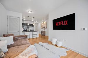 a living room with a couch and a kitchen at NEW! Luxury Champagne Towers Kingbed FreeParking in Atlanta +13 photos