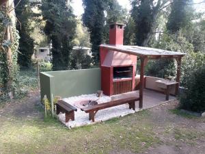 a play house with a bench and a bird house at Casa del Bosque in Mar del Plata