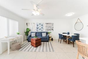 a living room with a blue couch and a table at Elegant Escape! in Boca Raton