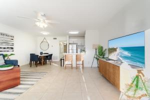 a living room with a large flat screen tv at Elegant Escape! in Boca Raton