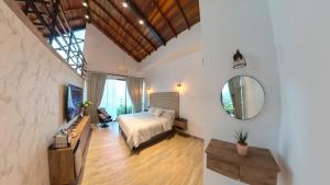 a bedroom with a bed and a mirror at Casa en el Cielo in Cali +42 photos