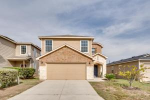 a house with a garage in a residential neighborhood at Near Hiking Trails Home with Deck in San Antonio! in San Antonio