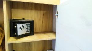 a small microwave in a shelf in a room at Studio apartman Eden sea view in Njivice