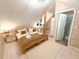 a bedroom with a large bed and a table at Landhotel Engel & Kreuz in Gaggenau