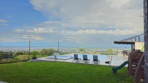a house with a pool with chairs and a view at Casa en el Cielo in Cali