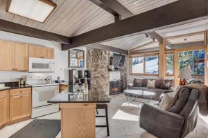 a kitchen and living room with a couch and a table at Laurelwood Condominiums 414 in Snowmass Village