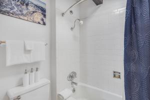 a white bathroom with a shower and a toilet at Laurelwood Condominiums 414 in Snowmass Village