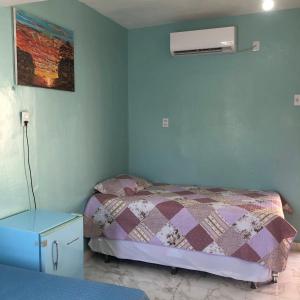 una camera con letto e condizionatore d'aria di Pousada Samreny a Maracanã