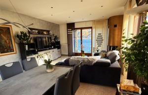 a living room with a couch and a table at apartment Lac Brusimpiano in Brusimpiano