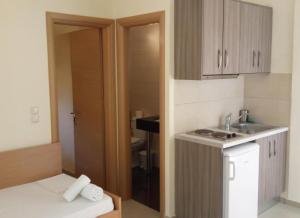 a small kitchen with a sink and a counter at Aristidis Garden in Parga