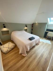 a bedroom with a bed and a wooden floor at Maison 4 Chambres Côte des Basques Avec Piscine in Biarritz +7 photos