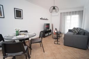 a living room with a table and a couch at Cozy stay by Flisvos Marina, ATH in Athens +11 photos