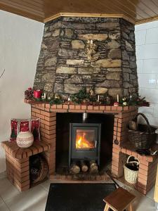 a brick fireplace with a fire in it at Casa dos Invernos in Paçô